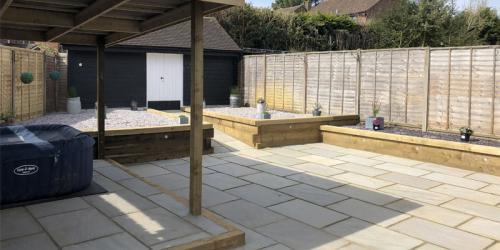Linear Indian Sandstone Paving with Softwood Sleeper Retaining Walls